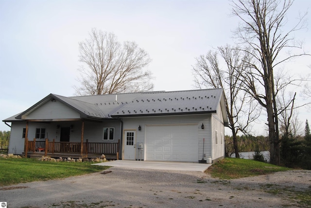 view of front of property featuring covered porch and a garage