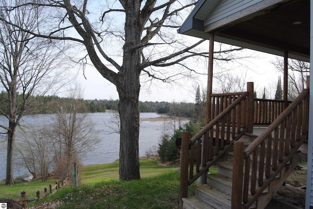 wooden terrace featuring a water view