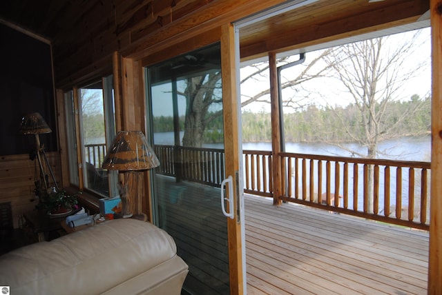 wooden terrace featuring a water view