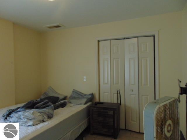 bedroom featuring a closet and light tile patterned flooring