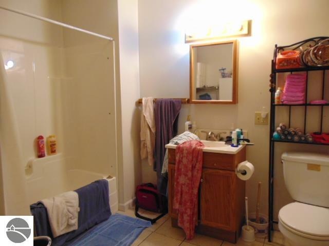 full bathroom with toilet, shower / tub combination, tile patterned floors, and vanity