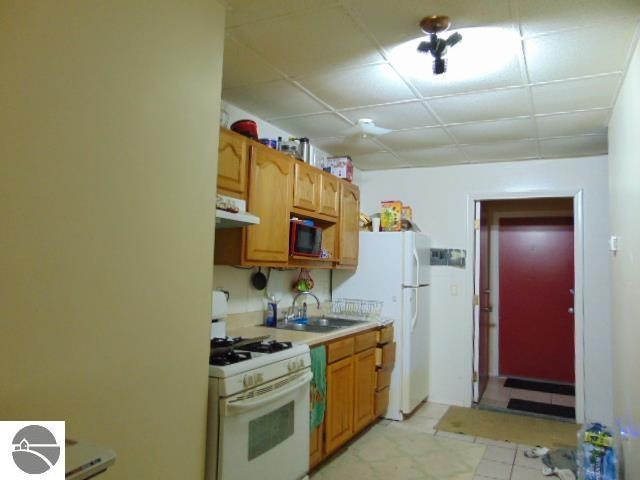 kitchen with sink and white appliances