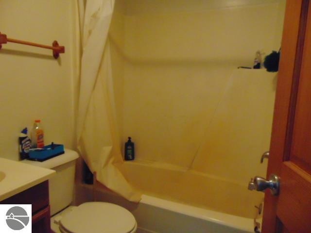 full bathroom featuring shower / tub combination, vanity, and toilet