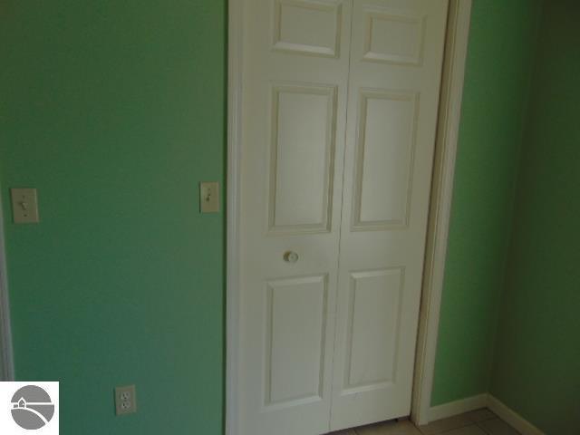 interior space featuring a closet and light tile patterned flooring