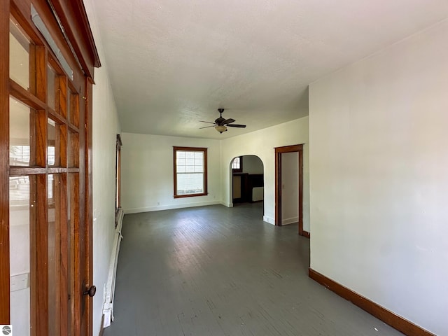 spare room featuring ceiling fan and dark hardwood / wood-style flooring