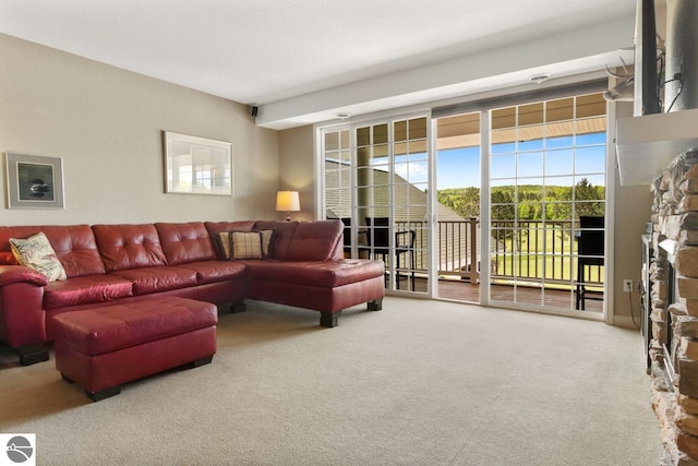 living room with carpet flooring and a fireplace