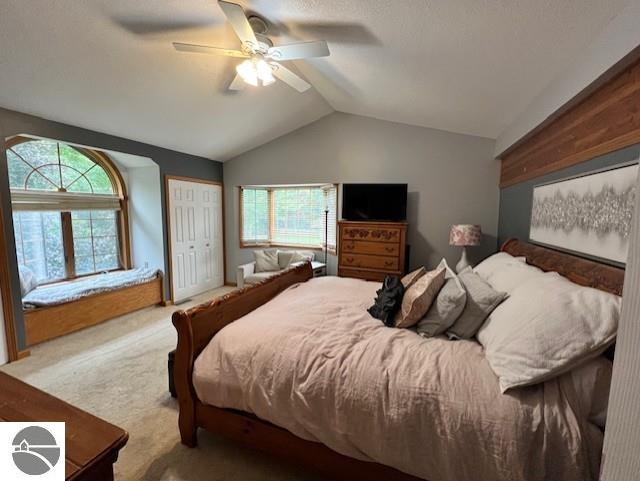 1165 E Lincoln St, East Tawas, MI 48730 - carpeted bedroom featuring vaulted ceiling, a closet, and ceiling fan