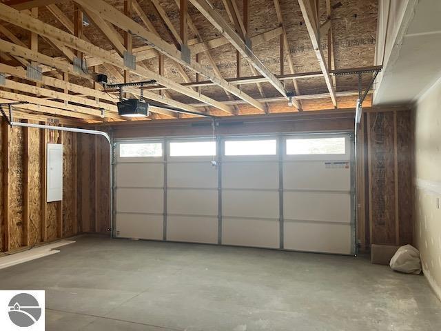 garage featuring a garage door opener and electric panel