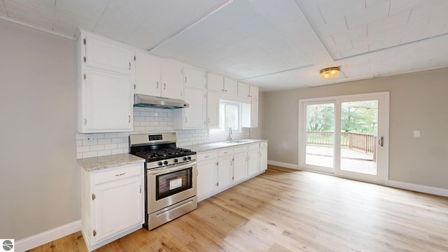 kitchen featuring white cabinets, stainless steel range with gas stovetop, and light hardwood / wood-style flooring