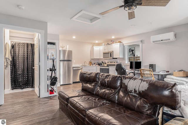 812 Forest Ave, Frankfort, MI 49635 - home theater with sink, hardwood / wood-style floors, ceiling fan, and a wall mounted AC