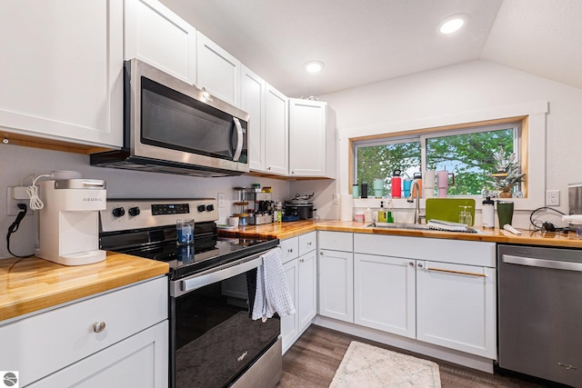 812 Forest Ave, Frankfort, MI 49635 - kitchen featuring appliances with stainless steel finishes, white cabinetry, sink, and butcher block counters