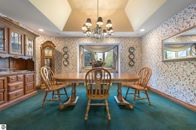 carpeted dining room with a notable chandelier, plenty of natural light, and a raised ceiling