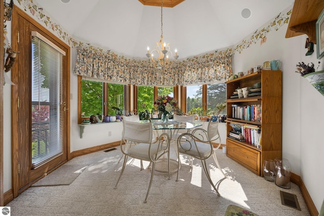 carpeted dining space featuring high vaulted ceiling, an inviting chandelier, and plenty of natural light