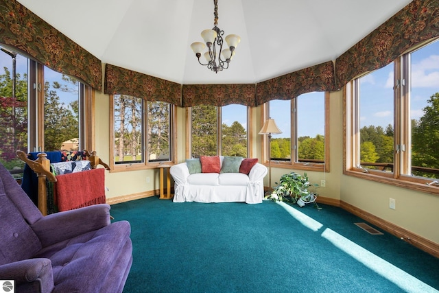 sunroom featuring a notable chandelier and vaulted ceiling