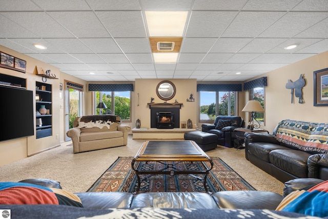 living room featuring a paneled ceiling