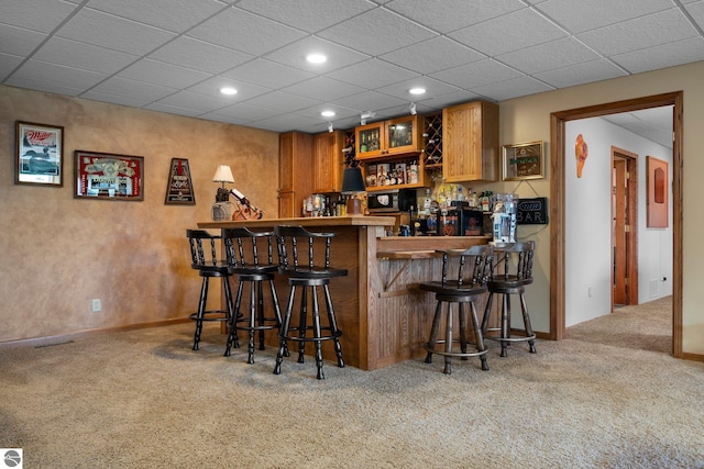 bar with carpet flooring and a paneled ceiling