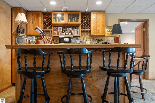 bar featuring carpet and a drop ceiling