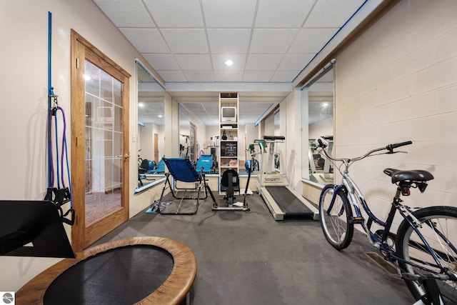 exercise room featuring french doors and a drop ceiling