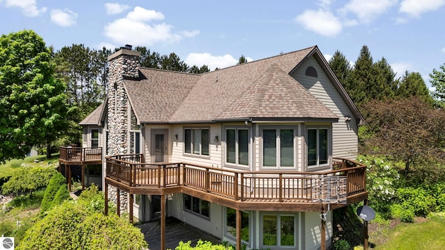 rear view of property with a wooden deck