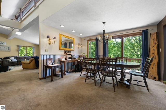 dining room with a notable chandelier, lofted ceiling, and carpet