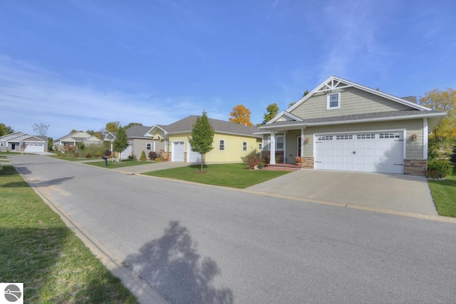 view of front of property featuring a garage and a front lawn