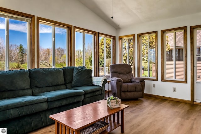 sunroom / solarium featuring lofted ceiling