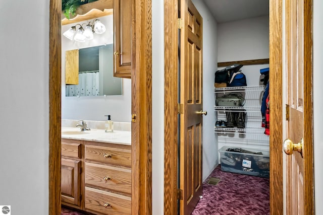 bathroom with curtained shower and vanity