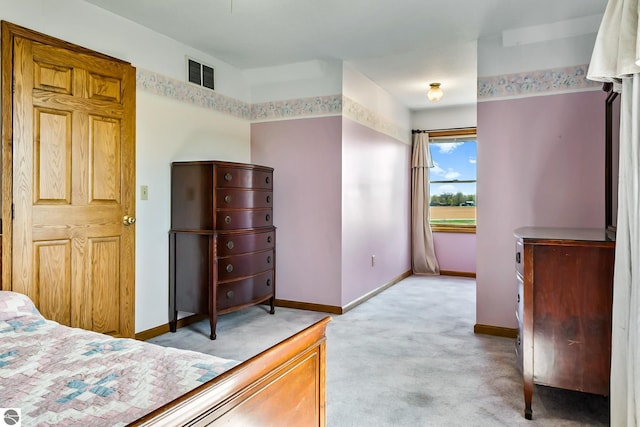 bedroom featuring light colored carpet