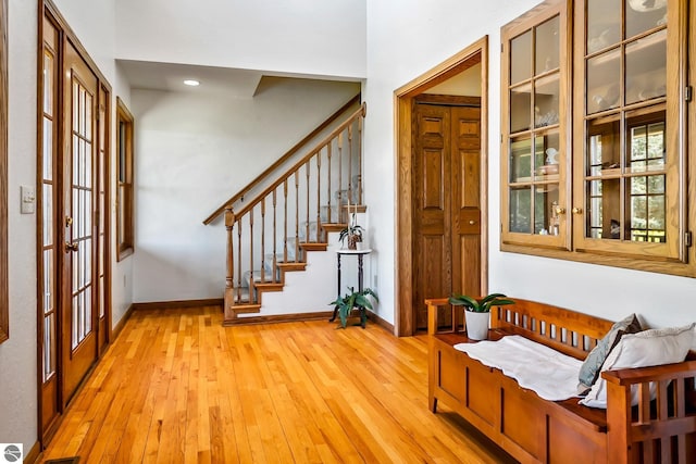 entrance foyer with light hardwood / wood-style floors and french doors