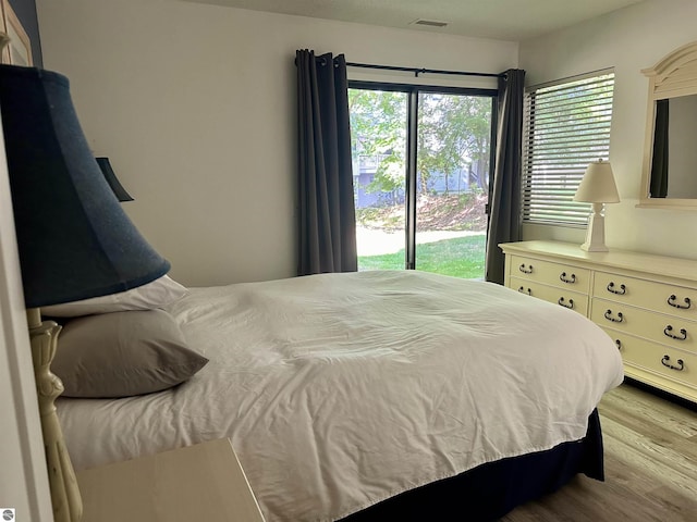 bedroom featuring light hardwood / wood-style flooring and access to outside