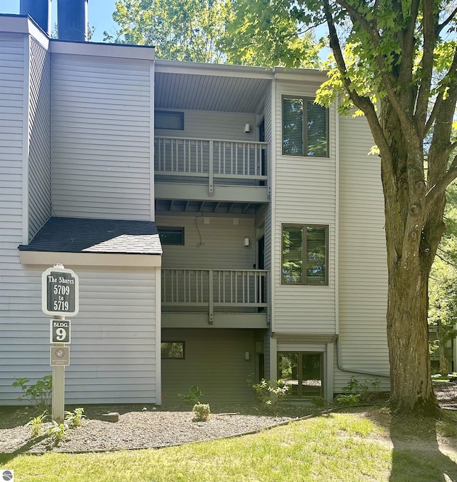 back of property featuring a balcony