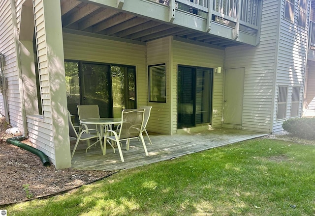 wooden terrace featuring a yard