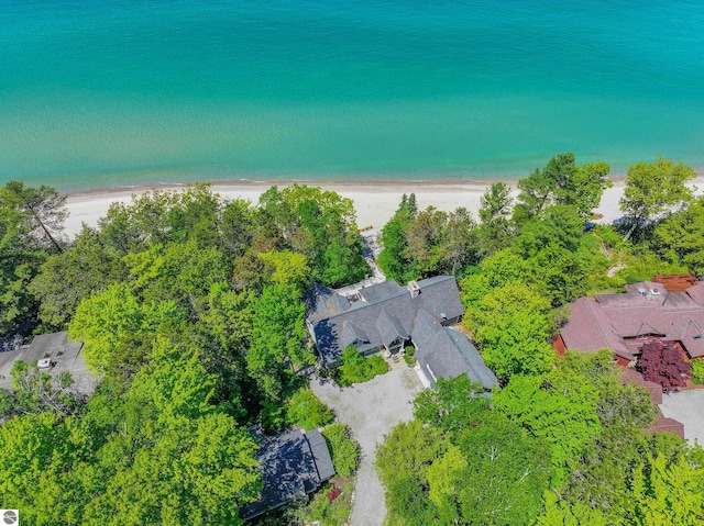 birds eye view of property with a beach view and a water view