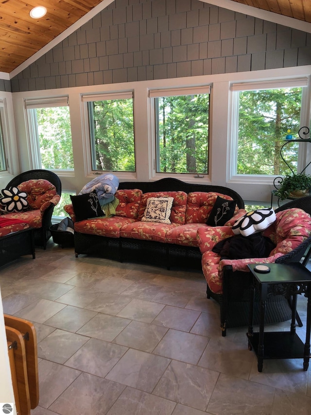 living room with a wealth of natural light, tile flooring, lofted ceiling, and wooden ceiling