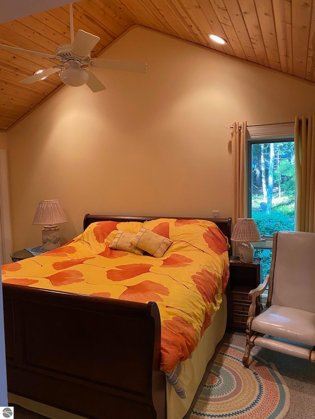 carpeted bedroom with vaulted ceiling, ceiling fan, and wood ceiling