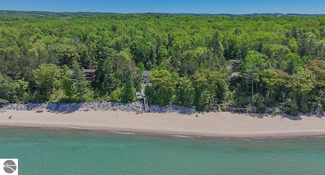 birds eye view of property featuring a beach view and a water view