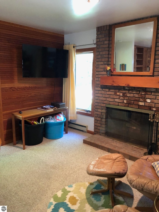 carpeted living room with a baseboard radiator, a fireplace, and brick wall