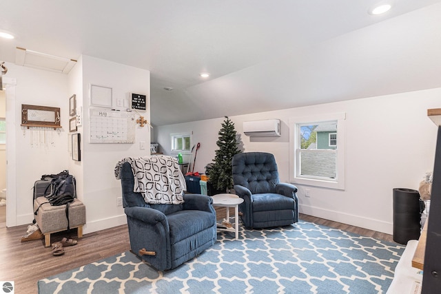 living area featuring a wall mounted air conditioner, vaulted ceiling, and wood-type flooring