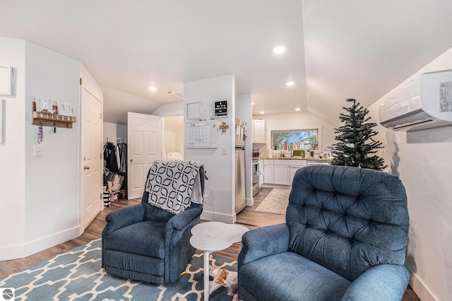 sitting room with vaulted ceiling and light hardwood / wood-style flooring