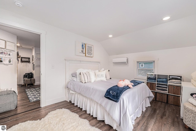 bedroom featuring dark hardwood / wood-style floors, vaulted ceiling, and a wall mounted AC