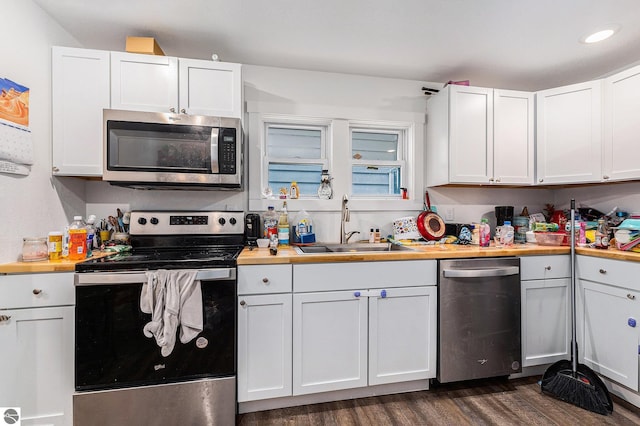 kitchen featuring stainless steel appliances, white cabinets, and sink