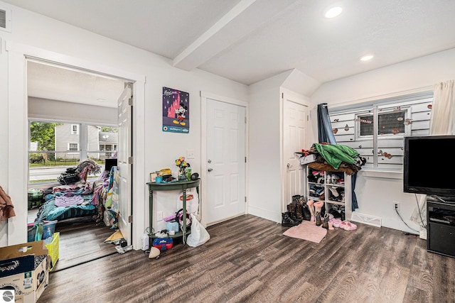 entryway with beam ceiling and dark hardwood / wood-style flooring