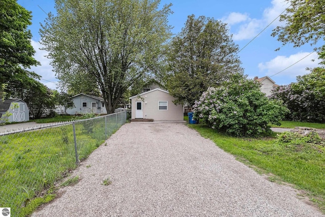 view of front of property with a storage shed