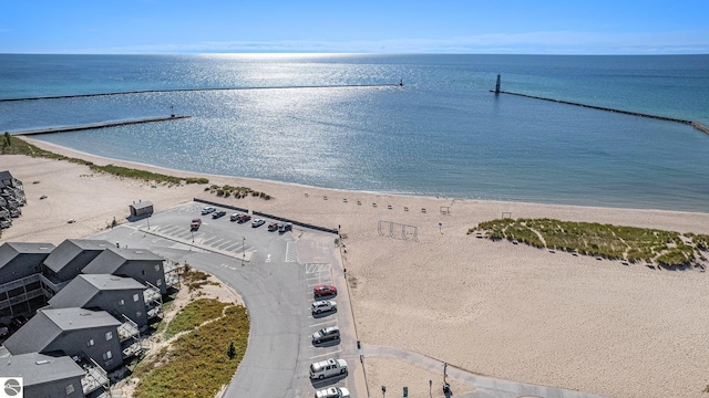 birds eye view of property with a view of the beach and a water view