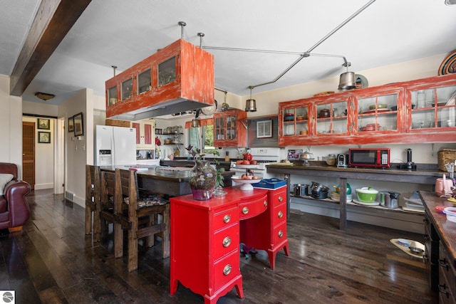 kitchen featuring a center island, white appliances, hanging light fixtures, and dark wood-type flooring