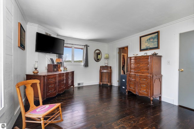 sitting room with crown molding and hardwood / wood-style flooring