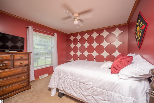 carpeted bedroom featuring ceiling fan and crown molding