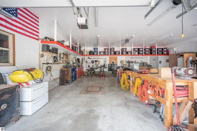 garage with a workshop area and a garage door opener