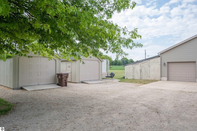 view of yard with a garage and an outdoor structure