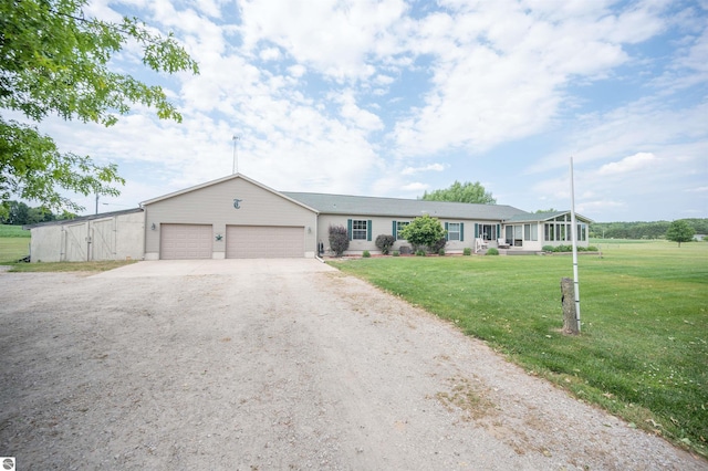 ranch-style home with a front yard and a garage